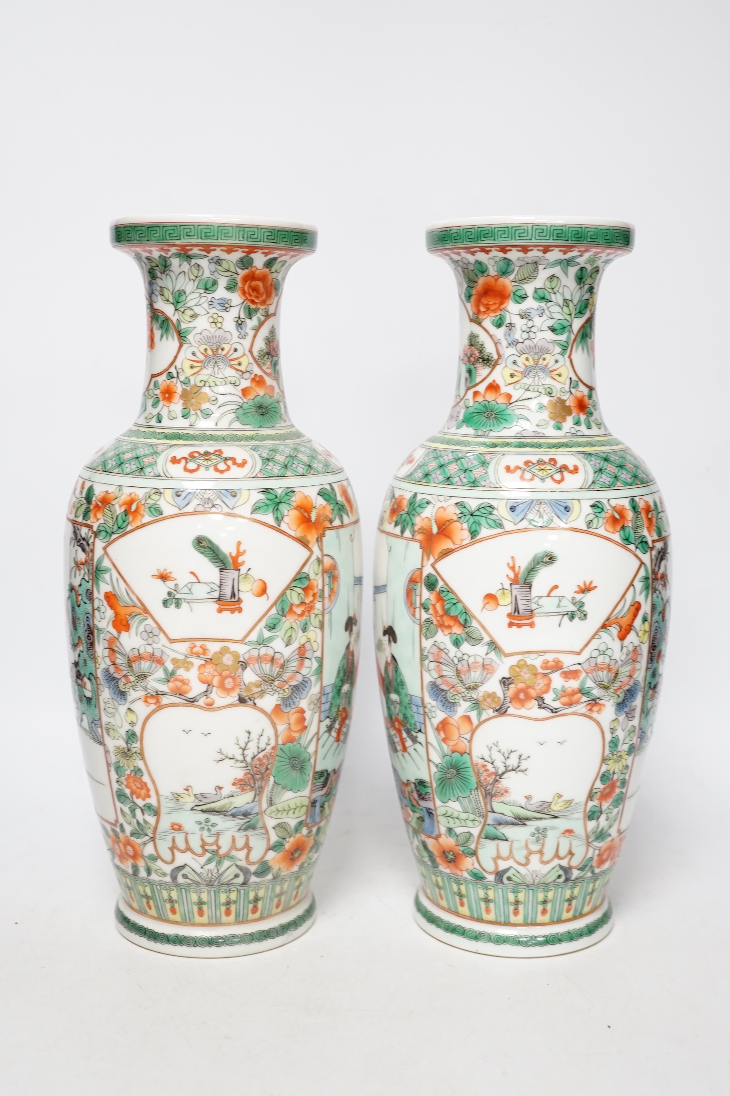 A pair of 20th century Chinese famille verte vases and a figure, tallest 31cm